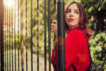 young woman in red sweater portrait outdoor at fall season city street