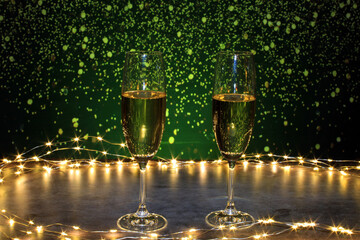 Champagne glasses surrounded by lights on a background of flashes