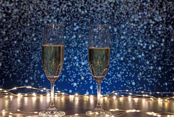 Champagne glasses surrounded by lights on a background of flashes