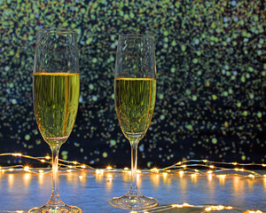 Champagne glasses surrounded by lights on a background of flashes