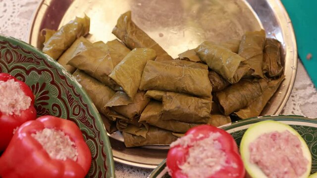 People cook dolma food.
Grape leaves stuffed with minced meat.