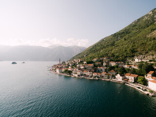 Fototapeta na wymiar Perast coast at the foot of the green mountain. Montenegro