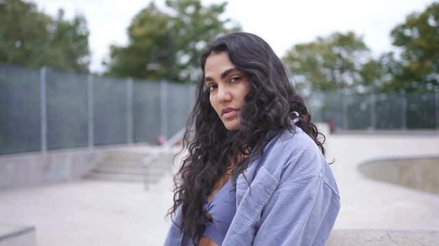 Young multi-ethnic hispanic millennial female on New York city. skateboarder girl hipster at skatepark. Urban modern student lifestyle, hipster fashion in NYC, healthy lifestyle, mixed race American.