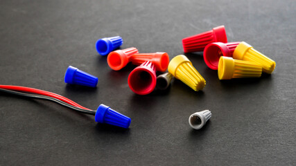 Electrical colorful wire connectors on black background