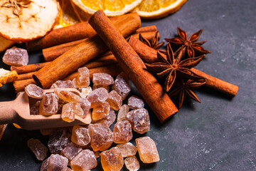 Closeup pile natural organic crystal brown rock sugar candy pile in vintage dark winter theme ingredient in sweet hot coffee spices beverage drink warm christmas mulled wine and dessert