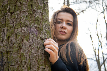 Beautiful girl in the woods near the trees