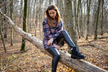 Beautiful girl in the woods near the trees