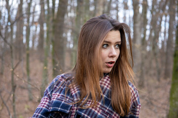Beautiful girl in the woods near the trees