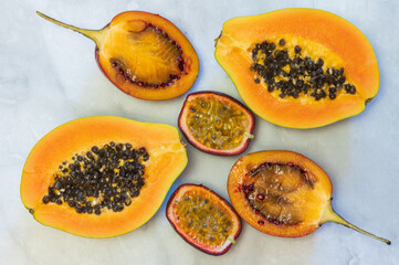 Halfs of tropical fruits papaya, tamarillo, passion fruit