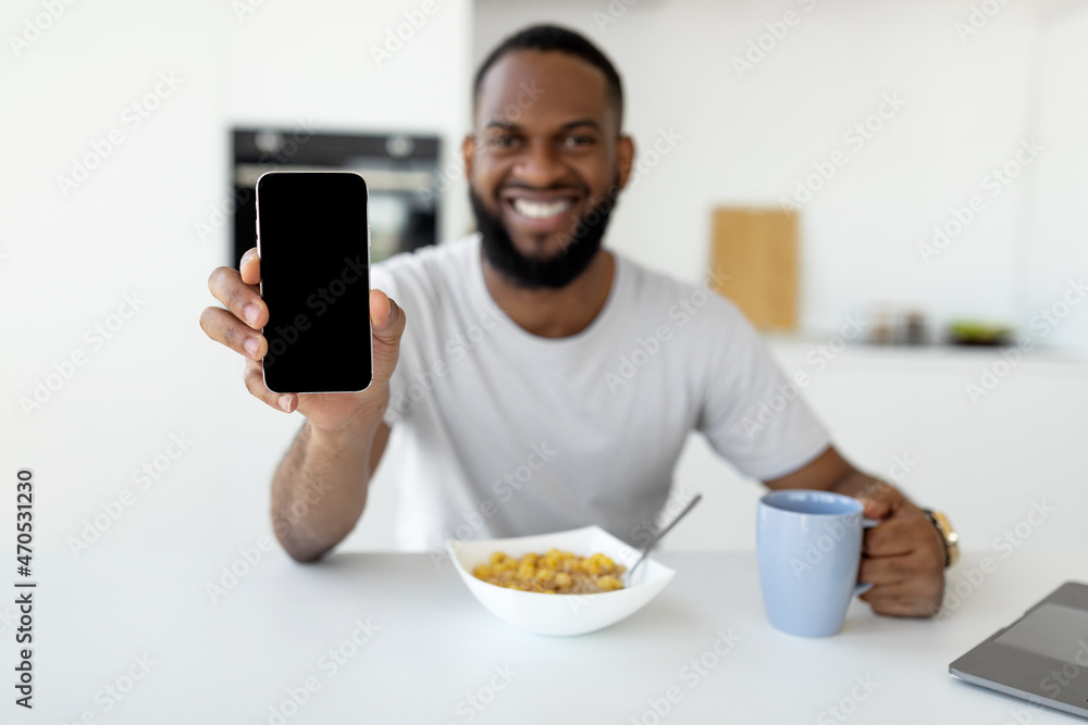 Aufkleber man showing white empty smartphone screen close to camera