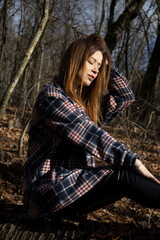 Beautiful girl in the woods near the trees
