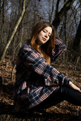 Beautiful girl in the woods near the trees