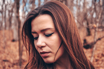 Beautiful girl in the woods near the trees