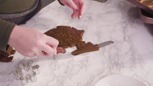 Step by step. Cutting out shapes with Christmas cookies cutter from gingerbread cookie dough.