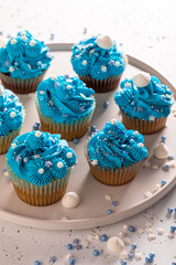 Homemade cupcakes made of blue cream for fat thursday.