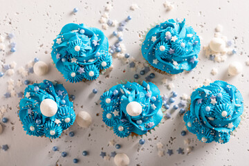 Unique cupcakes with flower shaped blue cream.