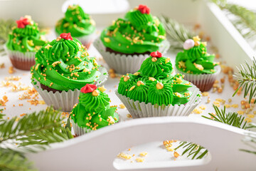 Homemade green cupcakes made of mint cream for fat thursday.
