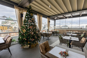 Interior of an empty restaurant with Christmas tree