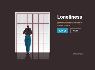 sad woman depressed girl standing in front of window loneliness and isolation depressive disorder problem