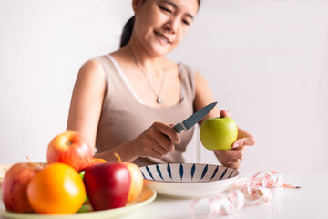 Women hands holding green apple and knife on white background,Healthy diet,Dieting concept