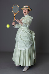 A Victorian woman wearing a tennis ensemble