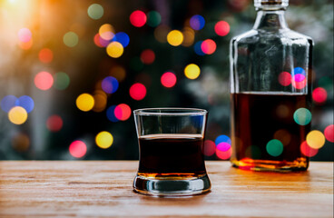 A glass of whiskey on wood bar, soft focus.	