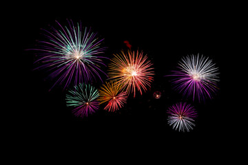 Fototapeta premium Many flashing colorful fireworks in event amazing with black background celebrate New Year, holiday and festival in night.