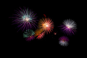 Many flashing colorful fireworks in event amazing with black background celebrate New Year, holiday and festival in night.