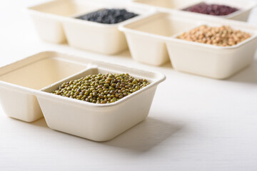 Mungbeans in compostable cardboard boxes are eco-friendly concepts and are mainly used as a plant-based ingredient in vegetarian, healthy food.