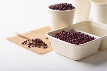 Fototapeta na wymiar Azuki bean in compostable cardboard boxes are eco-friendly concepts and are mainly used as a plant-based ingredient in vegetarian, healthy food.
