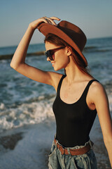 woman walking on the beach hat travel vacation sun