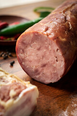 traditional german homemade smoked ham sausage on wood table