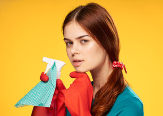 woman in rubber gloves detergent cleaning housework yellow background