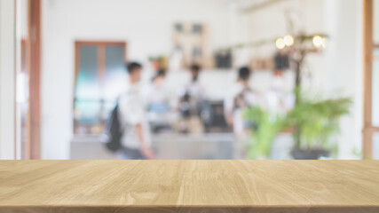 Empty wood table top and blurred coffee shop, cafe and restaurant interior background - can used...
