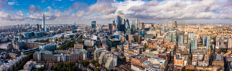 Fototapeta na wymiar Aerial panoramic scene of the London city financial district with many iconic skyscrapers near river Thames.