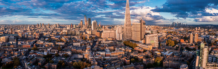 Obraz premium Aerial panorama of the London city financial district with many iconic skyscrapers near river Thames at sunset.