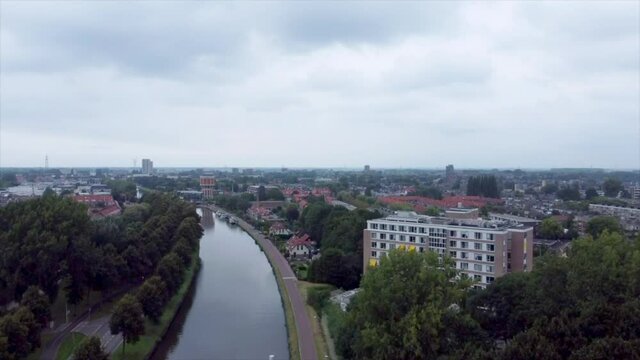 Aerial shot of elderly home along river flowing through suburbs of Leiden, the Netherlands