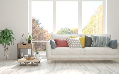 Stylish room in white color with sofa and autumn landscape in window. Scandinavian interior design. 3D illustration