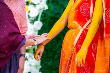 Indian Hindu pre wedding Haldi ceremony ritual items, turmeric, hands close up