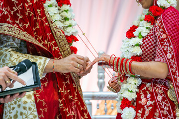 Fototapeta na wymiar Indian Hindu couple's ring exchange hands close up