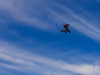 Fototapeta na wymiar Flying a motorized hang glider on an autumn sunny day.