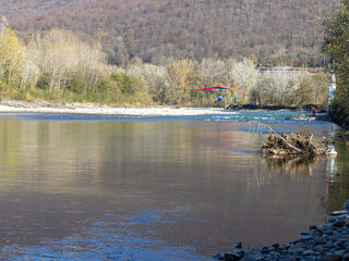 Flying a motorized hang glider on an autumn sunny day.