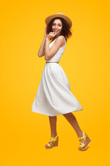 Graceful woman in summer dress in studio