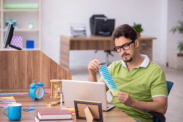 Young male designer working in the office