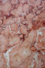 Texture background red marble with multiple strips and cracks. Vertical photo.
