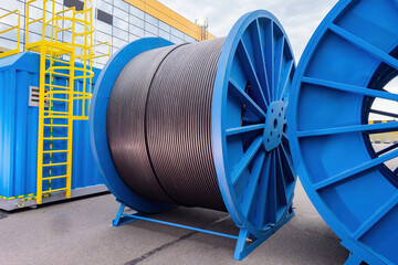 Large diameter cable reels. Power cables on metal coil. Concept - production of electrical wires....