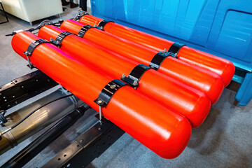 Fragment of truck with gas cylinders. Red cylinders with methane. Concept - driving on gas engine...