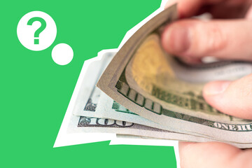 Man hands with dollars. He is counting dollars. Question mark as a metaphor for lack of money....
