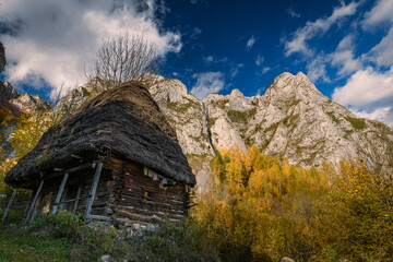 Small rural barn hut against an imposing mountain