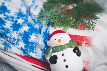 Snowman toy with USA flag background. with the concept of celebrating Christmas
